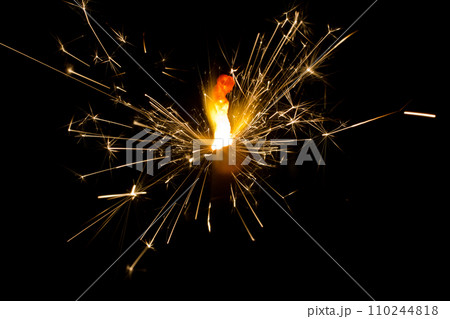 Dazzling Sparkler Display Against Dark Background 110244818