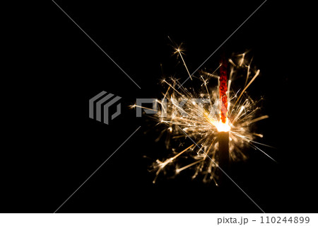 Glowing Sparkler Close-Up Against Dark Background in Fort Wayne 110244899