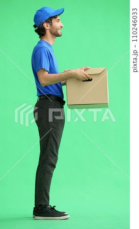 full-length male courier holding a box on a green background 110246033