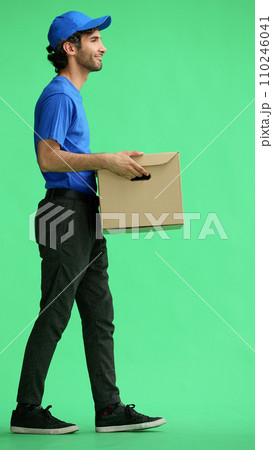 full-length male courier holding a box on a green background 110246041