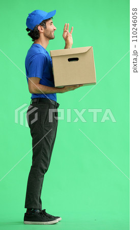 full-length male courier holding a box on a green background 110246058