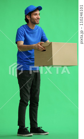 full-length male courier holding a box on a green background 110246101