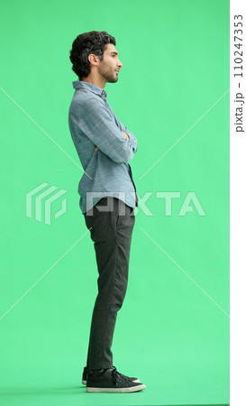 young man in full growth. isolated on green background profile young man in full growth. isolated on green background profile 110247353
