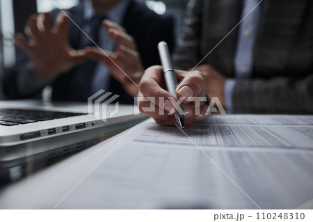 man looking through to documents. Business assessment and audit. 110248310