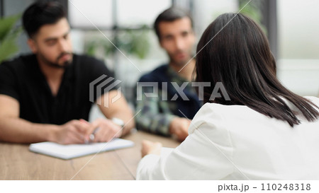 businessman a meeting with his colleagues in an office, while sitting with his team in a meeting room. businessman a meeting with his colleagues in an office, while sitting with his team in a meeting room. 110248318