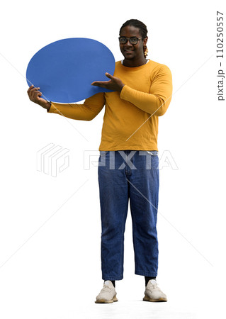 A man in a yellow sweater on a White background holds a blue comment sign A man in a yellow sweater on a White background holds a blue comment sign 110250557