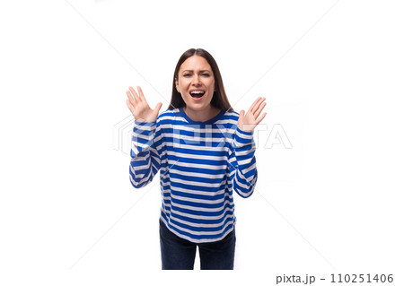 young groovy cheerful caucasian woman with dark hair dressed in a blue striped sweatshirt on a white 110251406