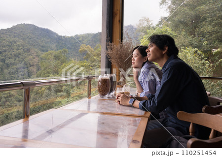 digital nomad concept asian couple freelancer relax and outdoor work at mountain view of coffeeshop digital nomad concept asian couple freelancer relax and outdoor work at mountain view of coffeeshop 110251454