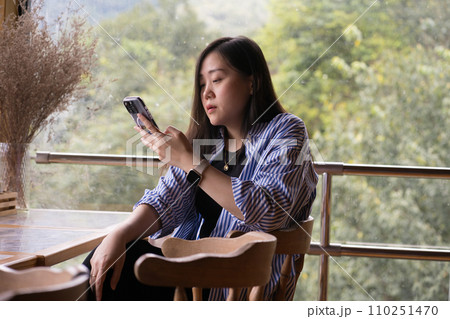 digital nomad concept asian freelancer woman use smart phone to work at mountain view of coffeeshop 110251470