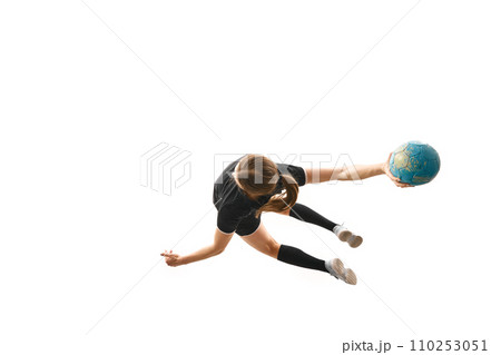 Skilled woman, handball player executing powerful throw, emphasizing determination and precision against white studio background. Concept of sport. 110253051