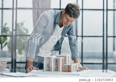 male architect designer examines the layout of the house. new project 110253063