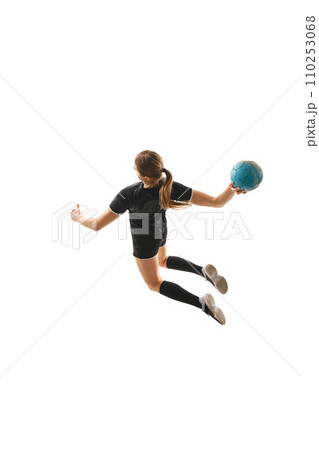 Top view portrait of skilled female handball player in motion, executing powerful throw with determination against white background. Concept of sport. 110253068