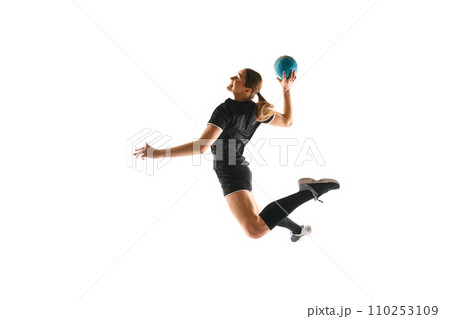 Determined female athlete practicing handball moves with concentration and dedication against white studio background. Concept of sport and action. 110253109