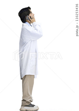 The guy is a doctor, on a white background, full-length, with a phone 110253436