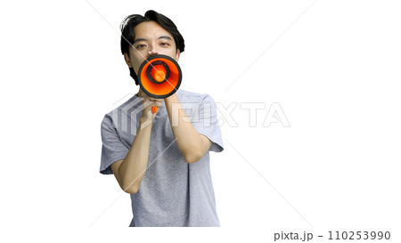 A guy in a gray T-shirt, on a white background, close-up, with a megaphone A guy in a gray T-shirt, on a white background, close-up, with a megaphone 110253990