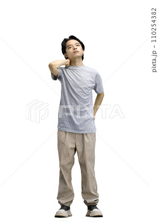 A guy in a gray T-shirt, on a white background, full-length A guy in a gray T-shirt, on a white background, full-length 110254382