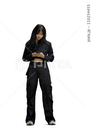 A woman in black clothes, on a white background, full-length, with a phone 110254455