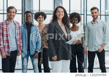 business woman with her staff in background at office business woman with her staff in background at office 110254704