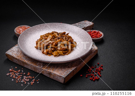 Delicious asian udon dish with vegetables, mushrooms, salt and spices Delicious asian udon dish with vegetables, mushrooms, salt and spices 110255116