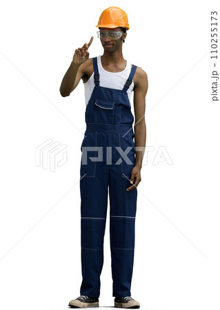 A male construction worker, on a white background, in full height, shows an important sign 110255173