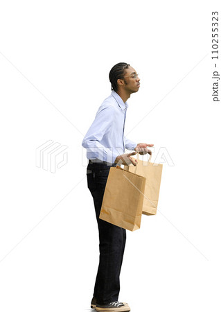 A man in a gray shirt, on a white background, full-length, with bags A man in a gray shirt, on a white background, full-length, with bags 110255323