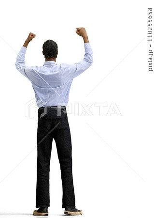 A man in a gray shirt, on a white background, in full height, raised his hands 110255658