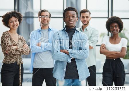 a group of successful business diverse people in the office stands embracing a group of successful business diverse people in the office stands embracing 110255773