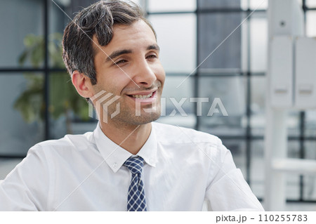 Confident and focused young designer standing in an office Confident and focused young designer standing in an office 110255783