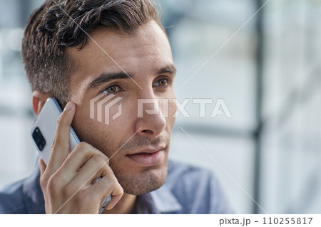 Businessman shopping over the phone in an office 110255817