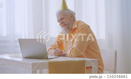 A lonely grandpa gratefully accepts birthday congratulations from relatives via a video call A lonely grandpa gratefully accepts birthday congratulations from relatives via a video call 110256661