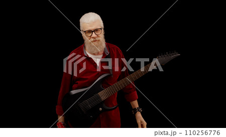 Exhausted senior man stops playing the electric guitar, struggling with notes and chords Exhausted senior man stops playing the electric guitar, struggling with notes and chords 110256776