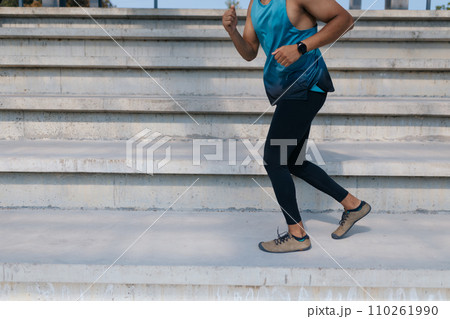 Close up of a man jumping on the stairs Close up of a man jumping on the stairs 110261990