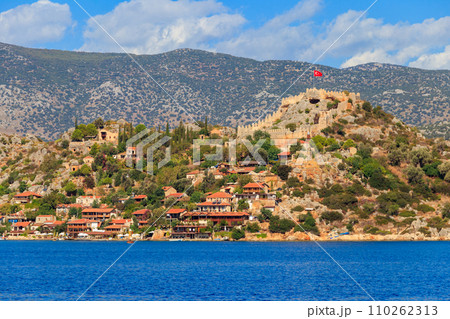 View of ancient Lycian town Simena with fortress on a mount on the coast of the Mediterranean sea in Antalya Province, Turkey View of ancient Lycian town Simena with fortress on a mount on the coast of the Mediterranean sea in Antalya Province, Turkey 110262313