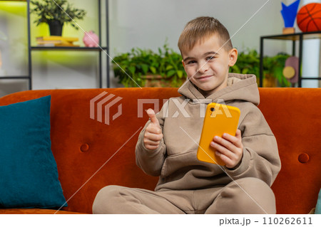 Young child kid boy texting share messages content on smartphone social media applications online 110262611