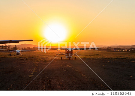 Small propeller airplanes at sunset in Arusha airport, Tanzania 110262642