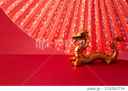2024 Chinese New Year with Oriental Dragon, folding fan on red background 110262734