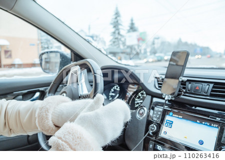 woman hands in winter gloves on steering wheel woman hands in winter gloves on steering wheel 110263416