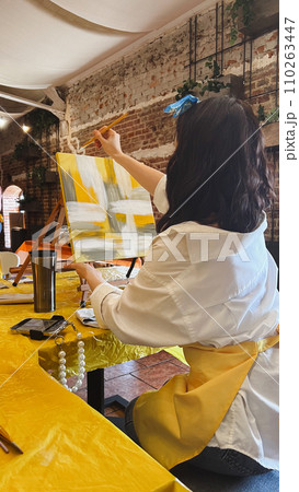 Woman with brush painting on canvas Woman with brush painting on canvas 110263447