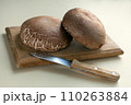 portobello mushrooms on wooden table. brown mushrooms, on a dark table with cutting board. Selective focus. 110263884