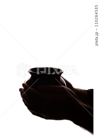 Hand young man holds ceramic pot - silhouette, concept 110264585