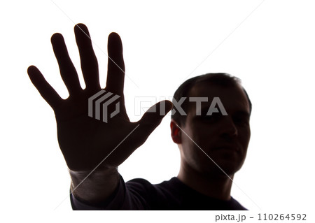 Hand young man covers his face, protest - silhouette, concept 110264592