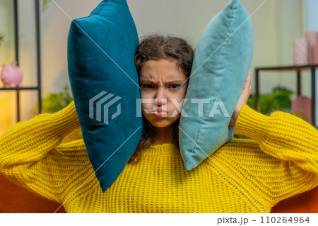 Neighbors repair work irritated girl by loud music at home cover ears with pillows annoyed by noise Neighbors repair work irritated girl by loud music at home cover ears with pillows annoyed by noise 110264964