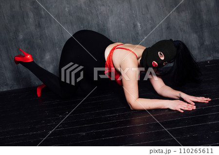 A masked woman in a dark room is a bandit 110265611