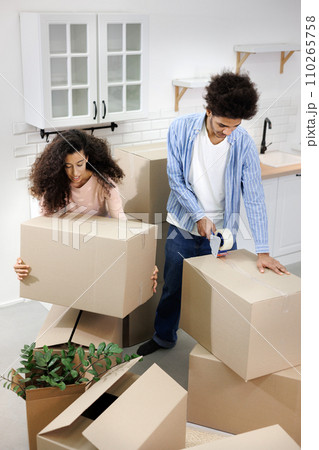 happy young people relocating to new home. purchase of residence, mortgage or rental.  110265758
