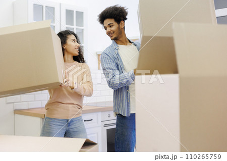 happy young people relocating to new home. purchase of residence, mortgage or rental. happy young people relocating to new home. purchase of residence, mortgage or rental. 110265759