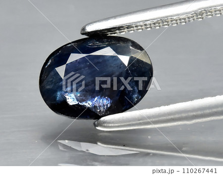 natural dark blue sapphire gem on the background natural dark blue sapphire gem on the background 110267441