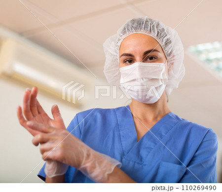 Nurse pulls gloves on her hands before the procedure Nurse pulls gloves on her hands before the procedure 110269490
