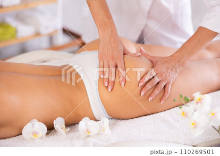 Close-up of young woman getting massage on her thighs and buttocks Close-up of young woman getting massage on her thighs and buttocks 110269501