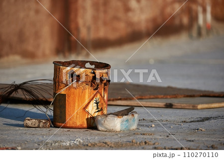 Rusty bucket remains at a construction site 110270110