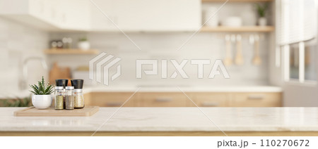 Spice bottles and copy space on a luxury white marble tabletop in a modern bright and clean kitchen. 110270672